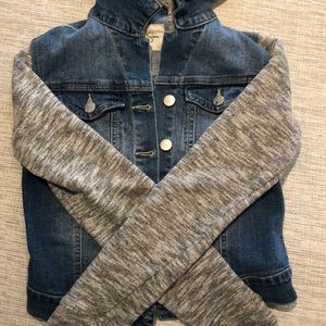Denim jean jacket with hoodie and fabric sleeves.